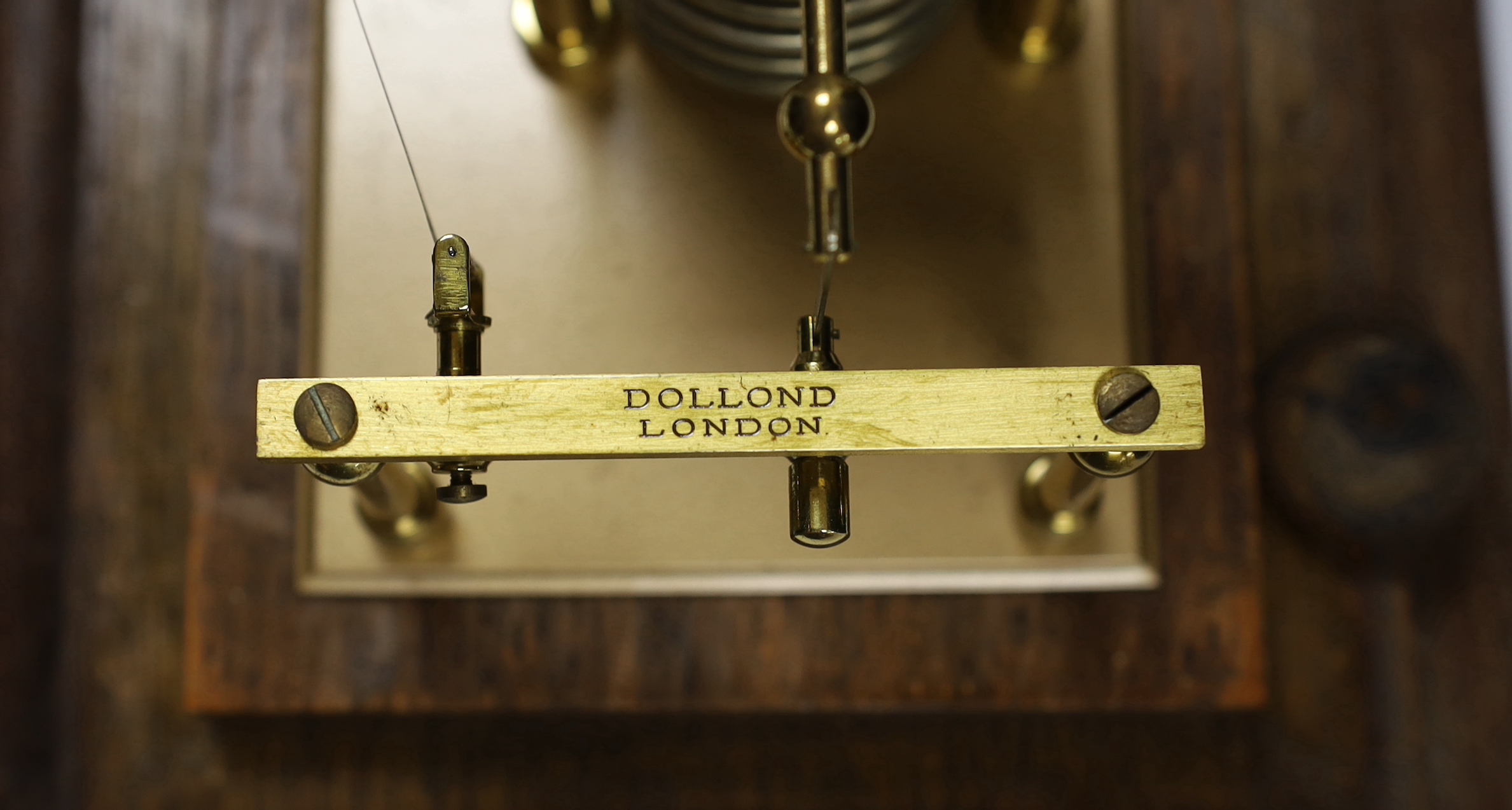 A barograph by Dollond in an oak case with bevelled glass panels and incorporating an ink bottle and a drawer with spare graph papers, 36.5cm x 21.5cm